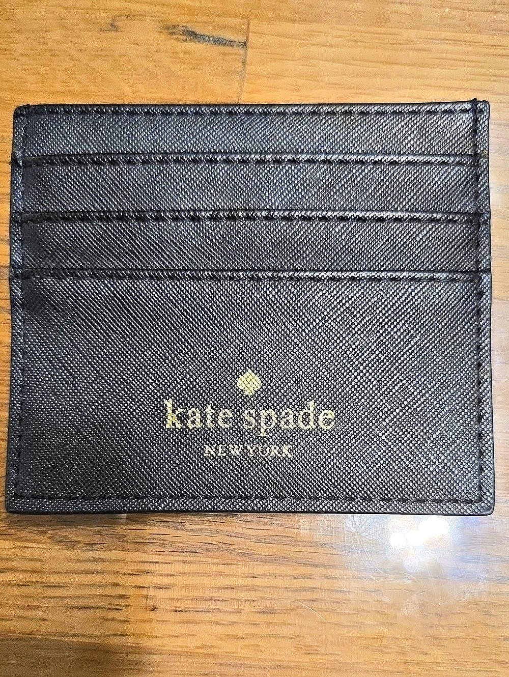 Kate Spade NEW YORK Glimmer Small Black Card Holder With Silver Glitter On back.